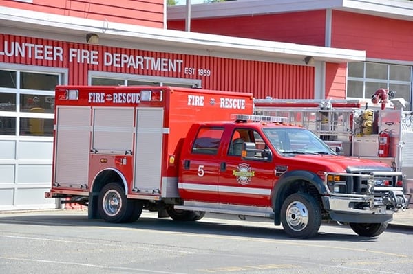 A fire and rescue truck outside a fire station