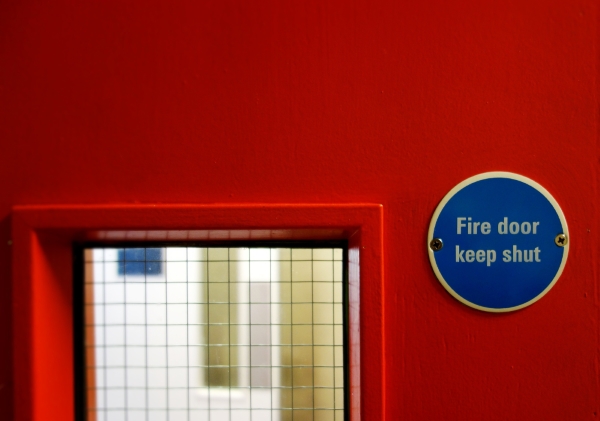 An interior fire door with a keep shut sign