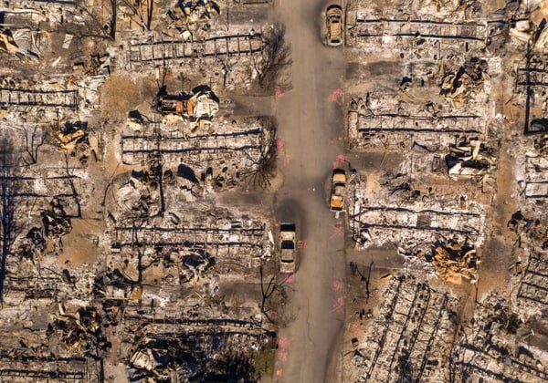 An aerial view of a neighborhood destroyed by a wildfire