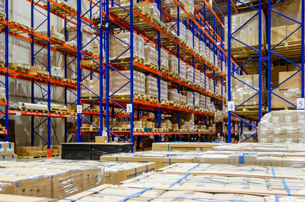 Large warehouse with metal shelves full of cardboard boxes